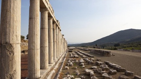 Many ancient columns, diminishing in size due to perspective, in the Pelopponese region, Greece.