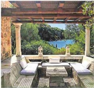 Fermor House, an historic landmark visited while on the Making Art in Greece tour in the Pelopponese. The photo shows a seating area in the home that overlooks water.