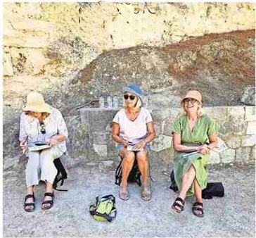 Lee Tuloch sitting with two fellow travellers while on the Making Art in Greece tour through the Pelopponese.